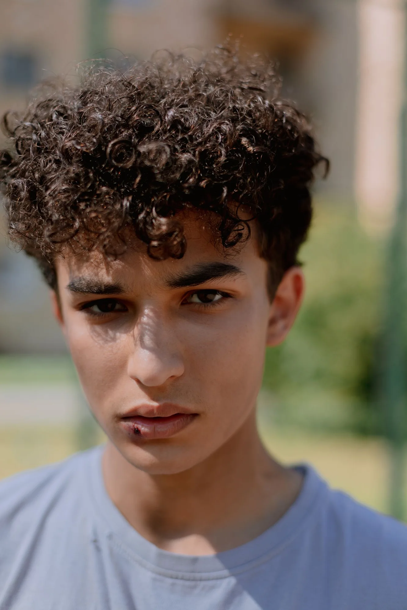 Close portrait of natural curly hair with shorter sides