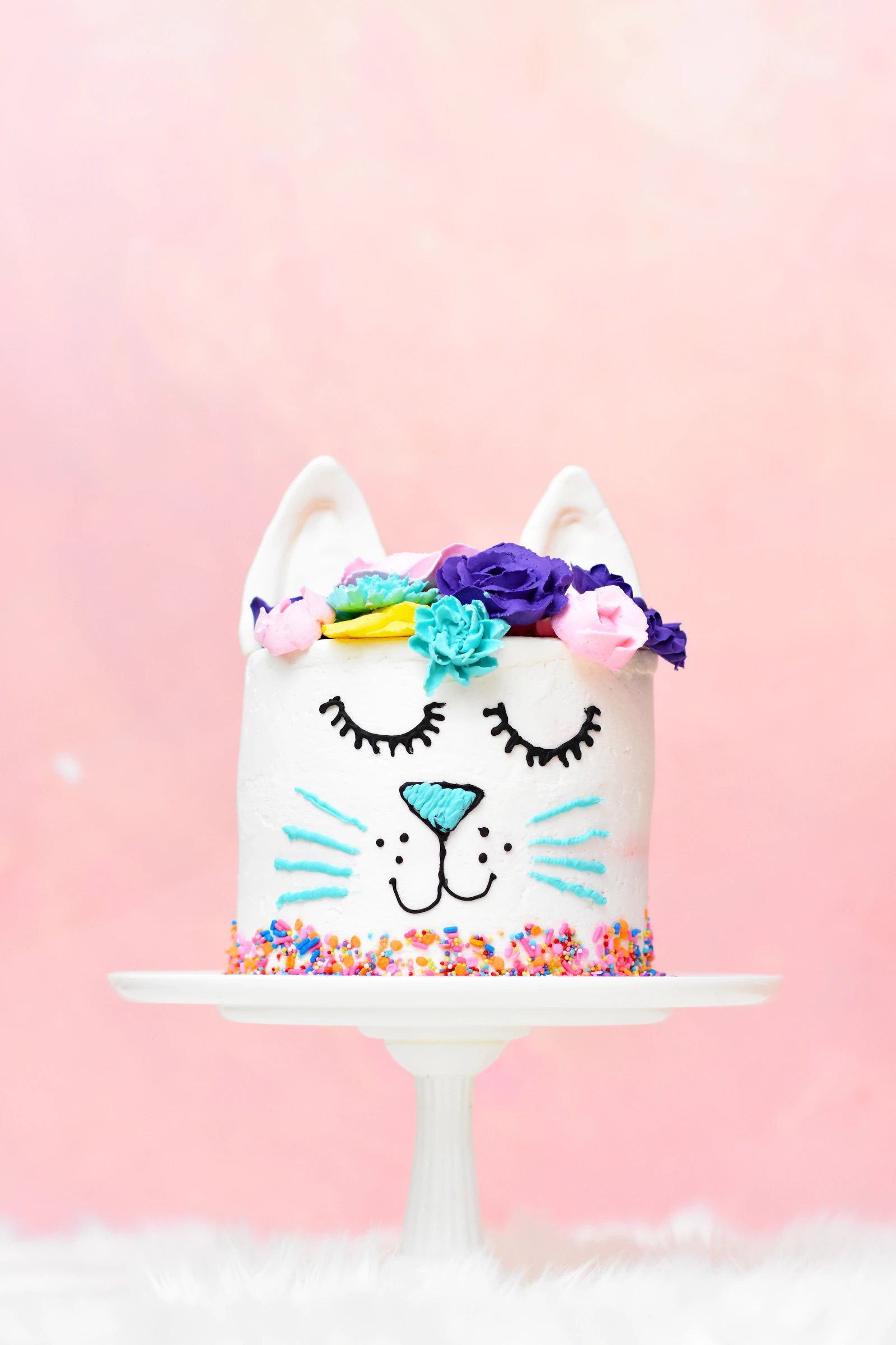 A decorated celebration cake with bright flowers