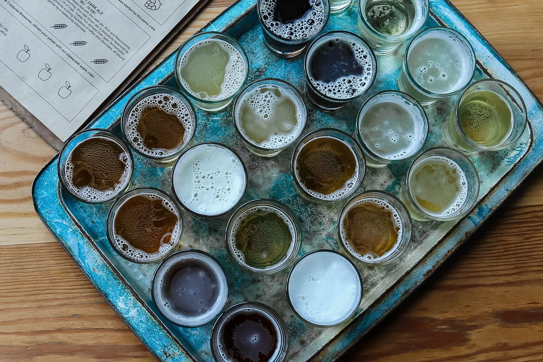 Small glasses of beer arranged on a tray