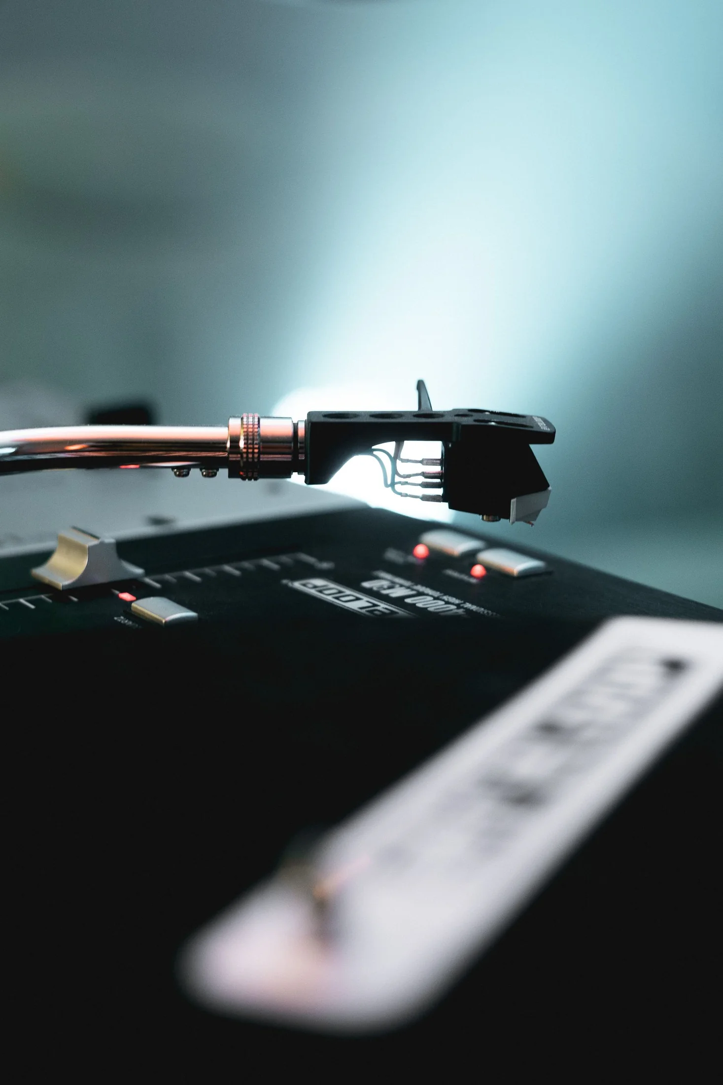A turntable tonearm and stylus in close detail