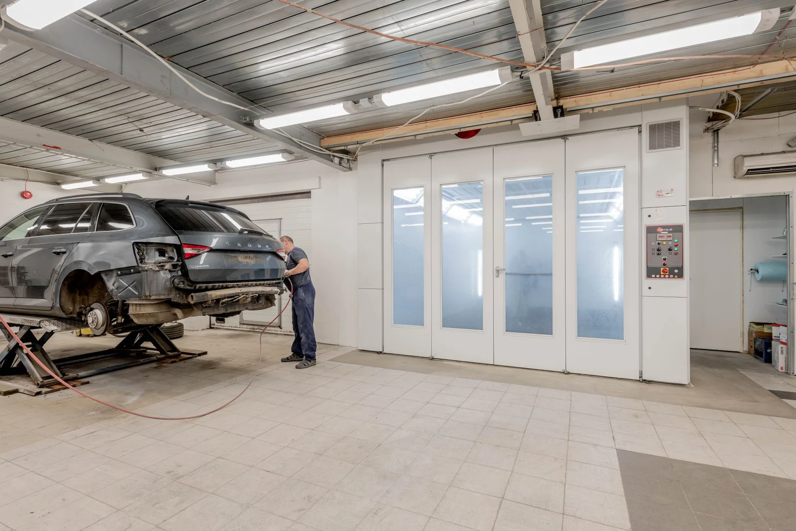 Car body repair in an automotive workshop with a paint booth
