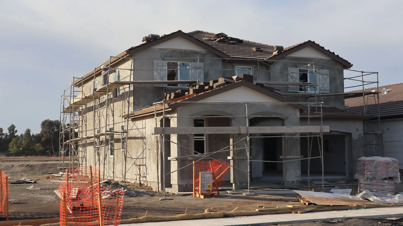 House under construction with scaffolding around the exterior