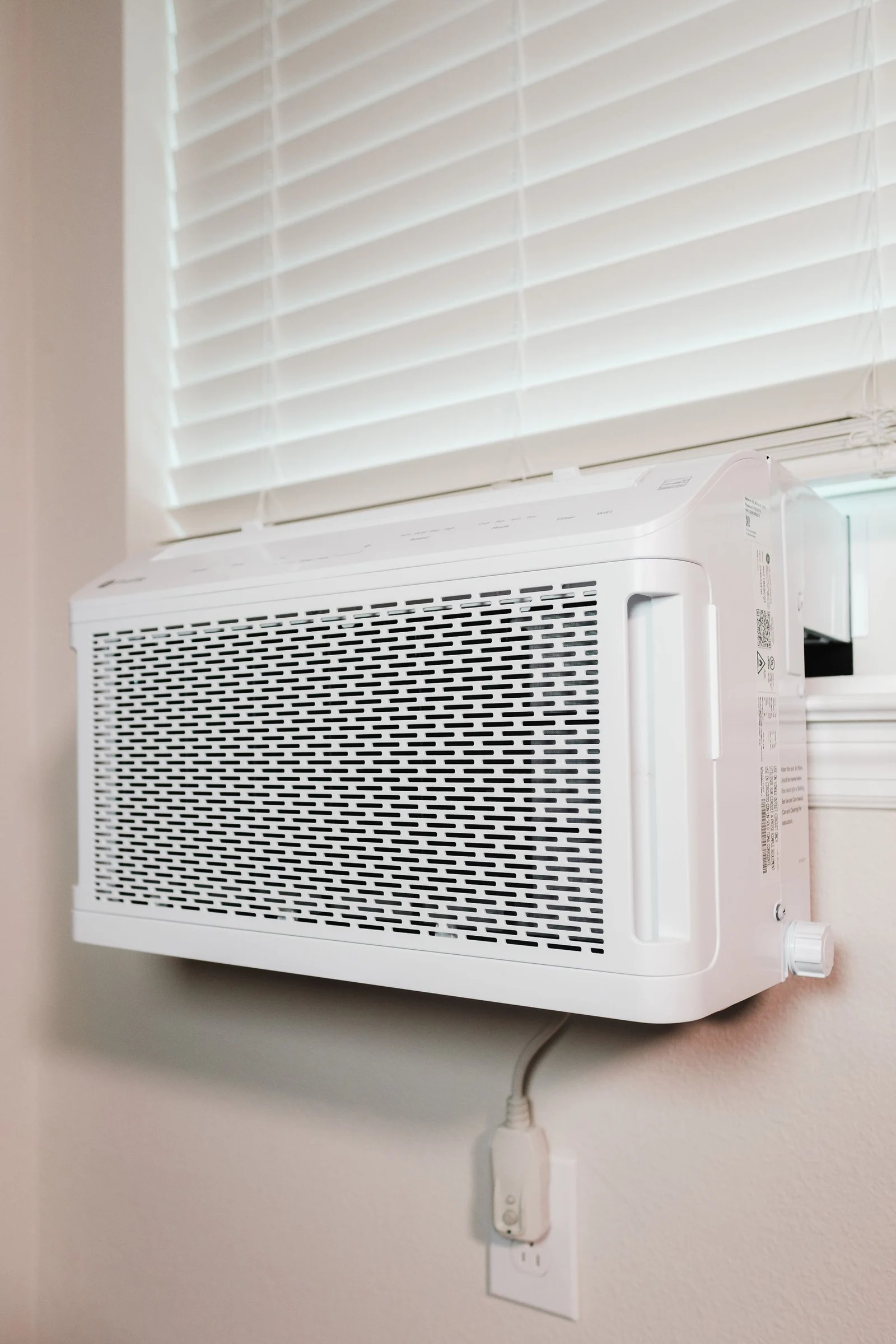 Window-mounted air conditioner in a bright domestic room