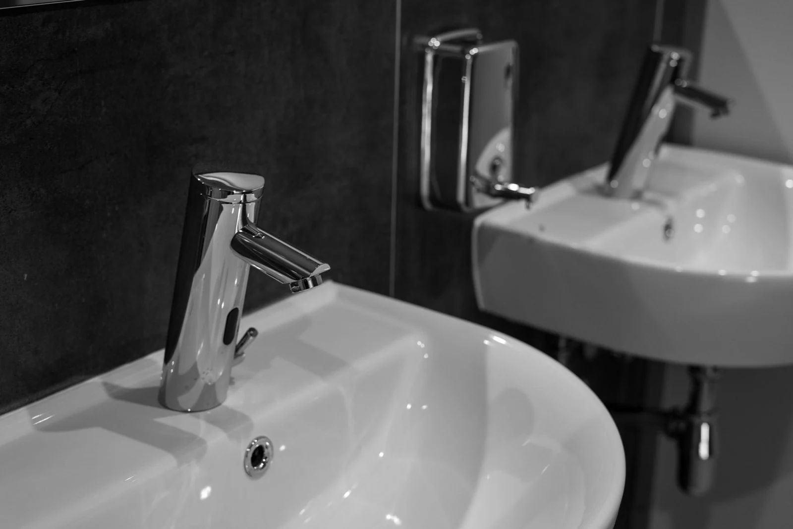 Commercial sensor faucets with a monochrome finish