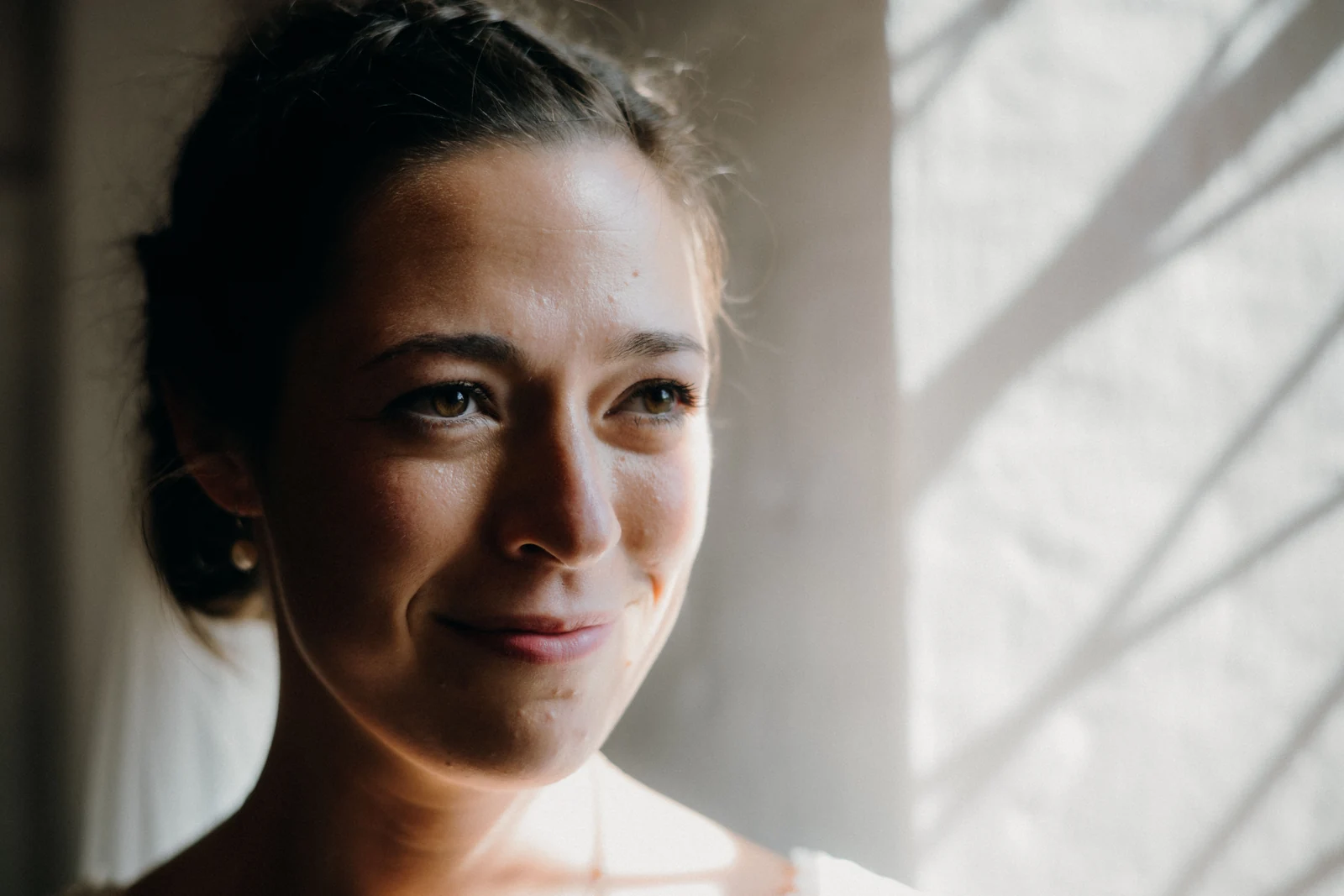 Natural-light portrait beside a window, illustrative stock photograph