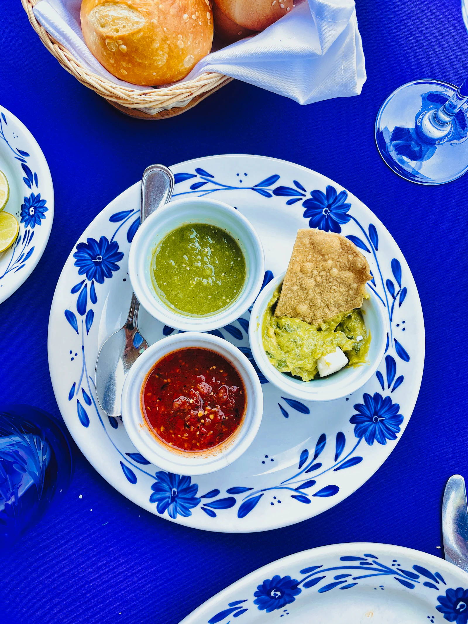 Salsas and guacamole on blue-and-white tableware